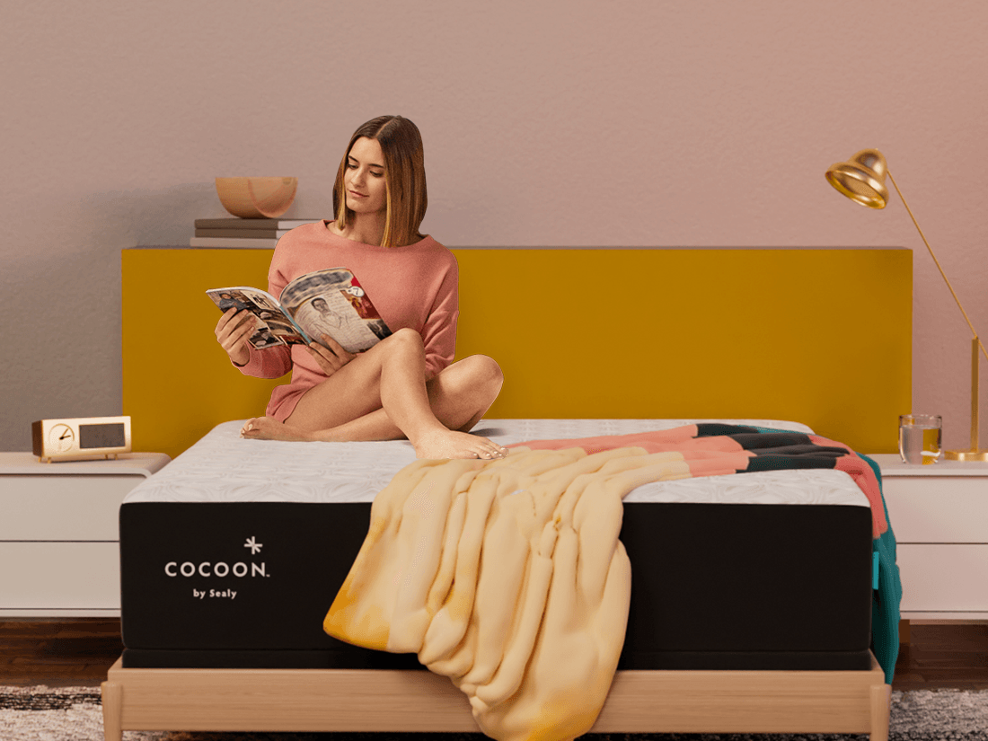 woman sitting up in bed reading