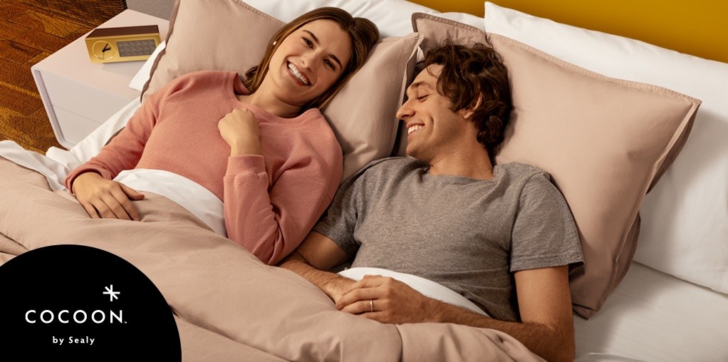 Couple laying on dressed Cocoon bed