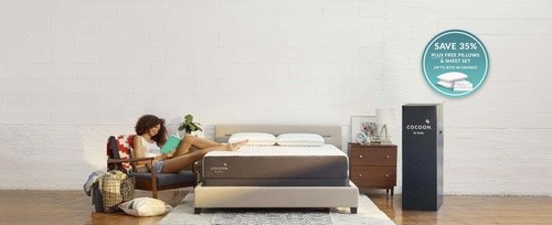 Image of woman reading next to her Cocoon mattress and a savings badge in the corner that says "Save 35% plus free pillow and sheet set, up to $799 in savings""